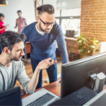 Developers looking at a computer