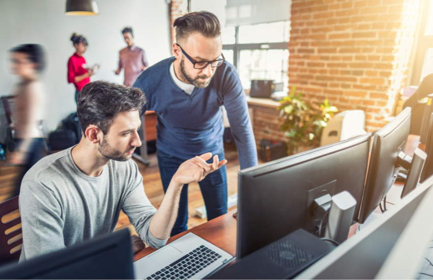 Developers looking at a computer