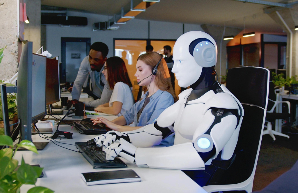 Robots working on computer next to humans